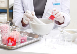 A pharmacist preparing medication with mortar